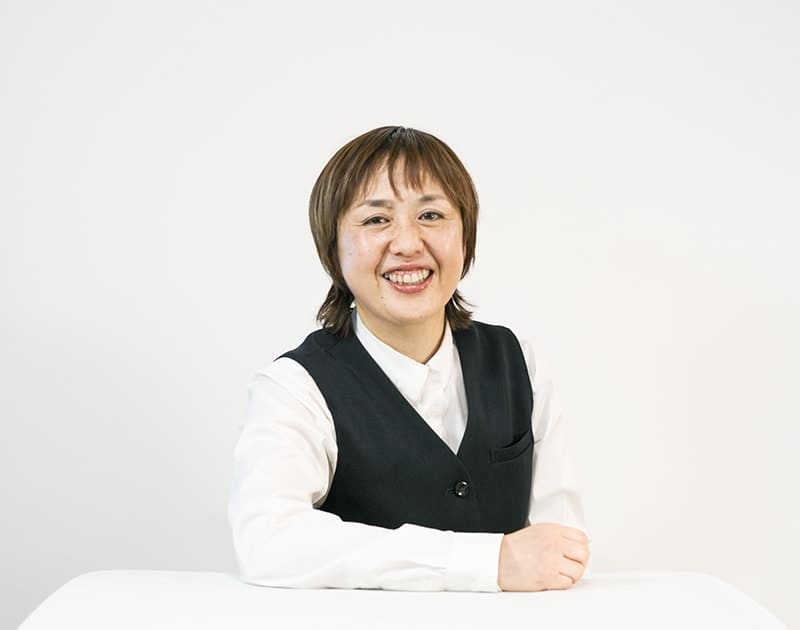 本部スタッフのN.S.さん。白いシャツに黒いベスト姿